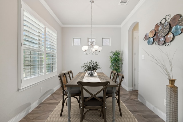 dining area with wood-type flooring, ornamental molding, and a chandelier