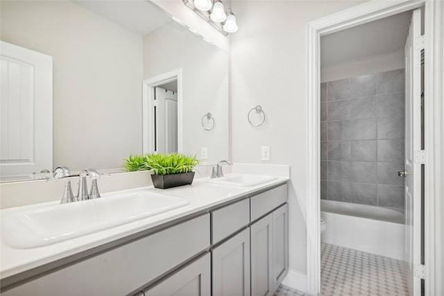 full bathroom featuring vanity, tile patterned flooring, tiled shower / bath combo, and toilet