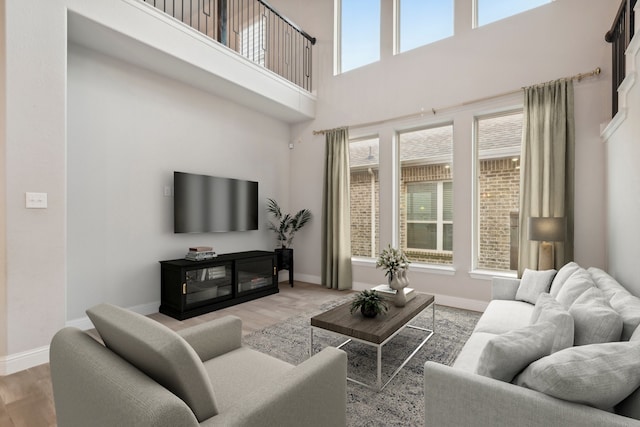 living room featuring hardwood / wood-style flooring and a high ceiling