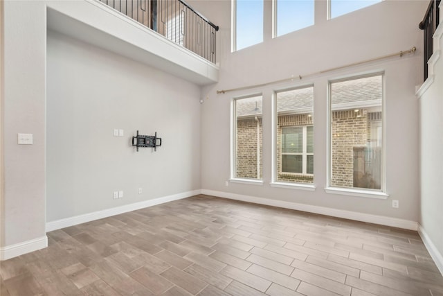 unfurnished room with a towering ceiling