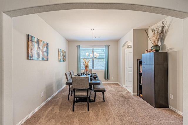 dining room featuring a notable chandelier and carpet