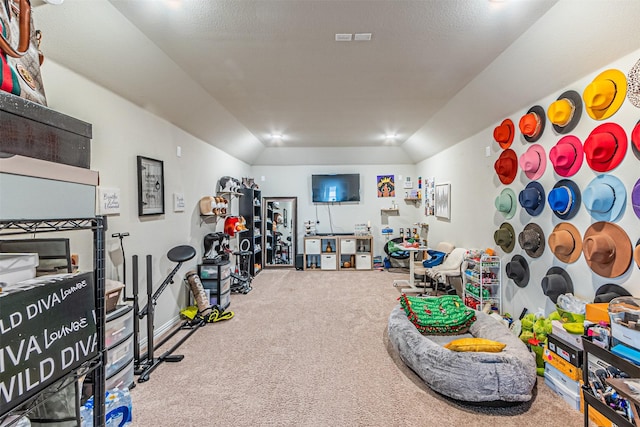 recreation room with vaulted ceiling and carpet