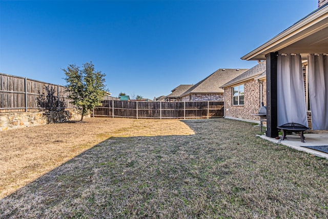 view of yard with an outdoor fire pit