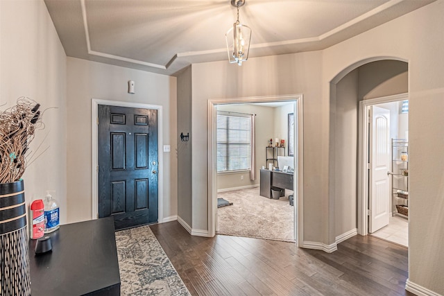 entrance foyer with hardwood / wood-style flooring and a raised ceiling