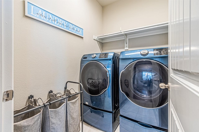 laundry room with separate washer and dryer and tile patterned floors