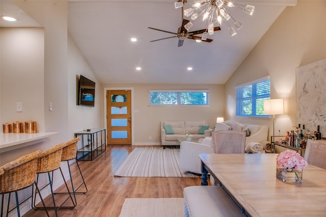 interior space with ceiling fan, lofted ceiling, and light hardwood / wood-style flooring