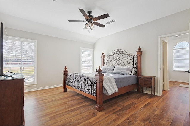 bedroom with multiple windows, wood finished floors, and visible vents