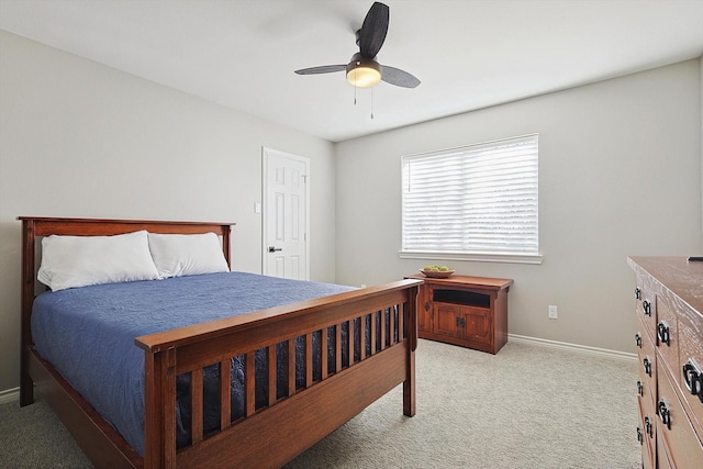 bedroom with baseboards, ceiling fan, and light colored carpet