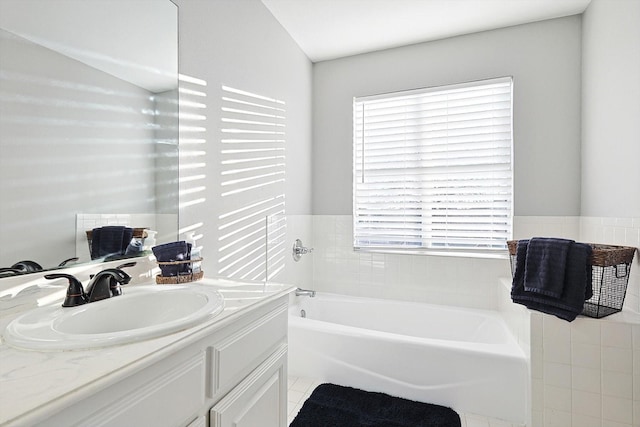 bathroom featuring a garden tub and vanity