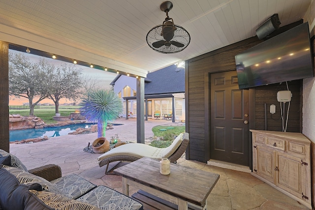 view of patio / terrace with a ceiling fan and an outdoor pool