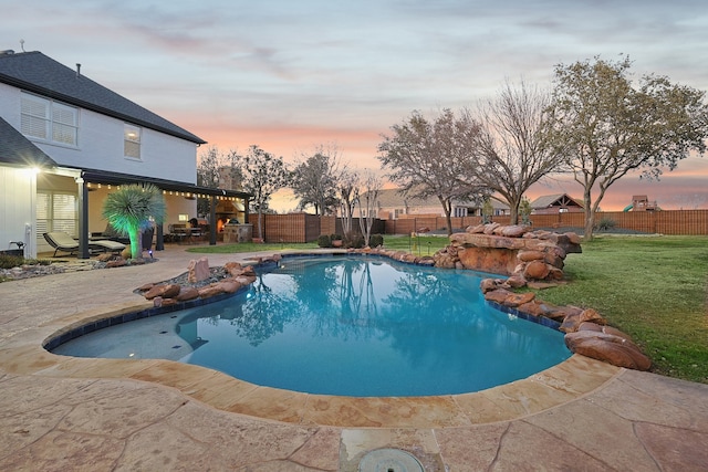 view of swimming pool with a patio, a lawn, a fenced backyard, and a fenced in pool