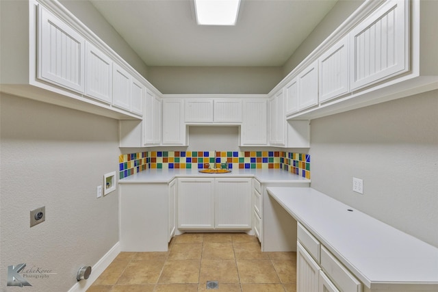 washroom featuring cabinets, hookup for a washing machine, light tile patterned floors, and electric dryer hookup