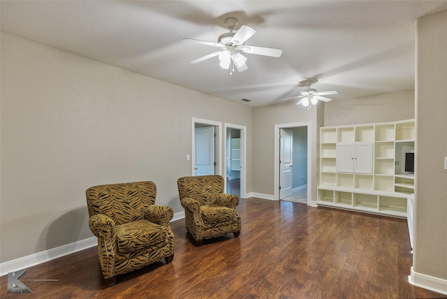 sitting room with ceiling fan and dark hardwood / wood-style flooring