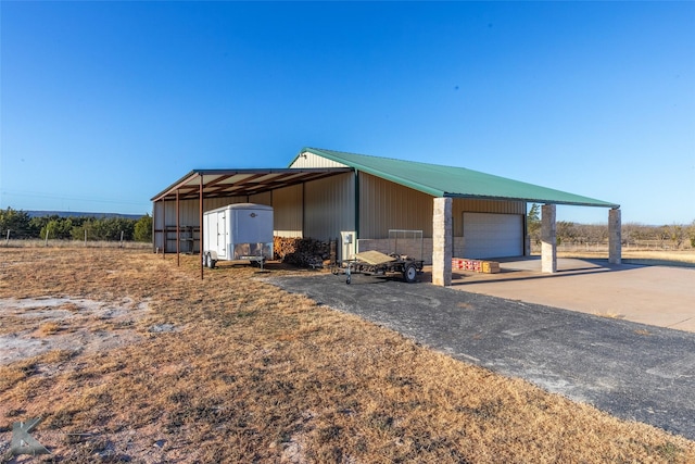 view of front of home featuring a garage and an outdoor structure