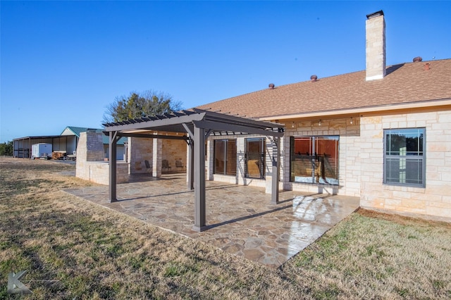 back of property featuring a yard, a pergola, and a patio area