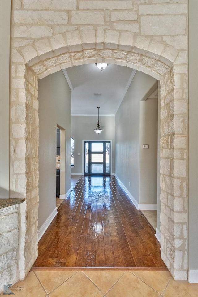 hallway featuring crown molding and hardwood / wood-style floors