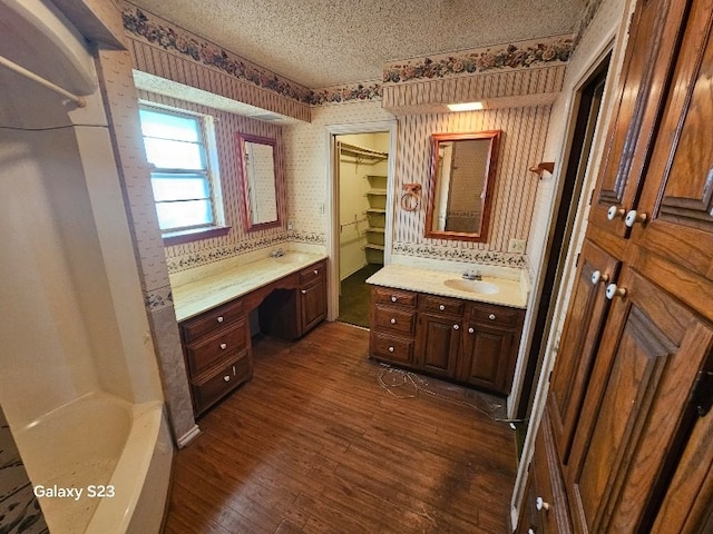 bathroom featuring vanity, hardwood / wood-style flooring, and a textured ceiling