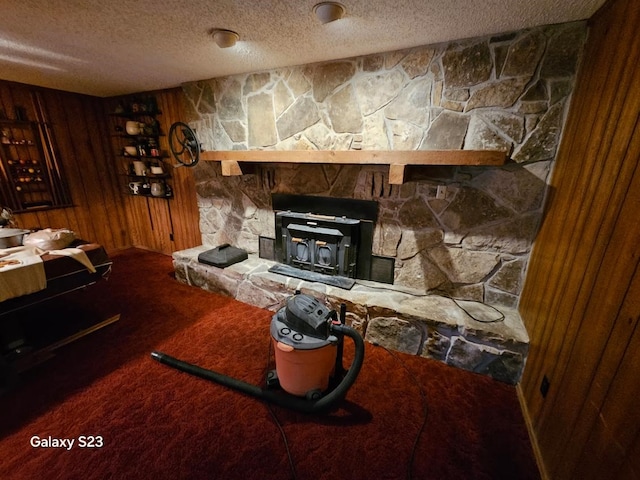 unfurnished living room with carpet floors, a textured ceiling, and wood walls