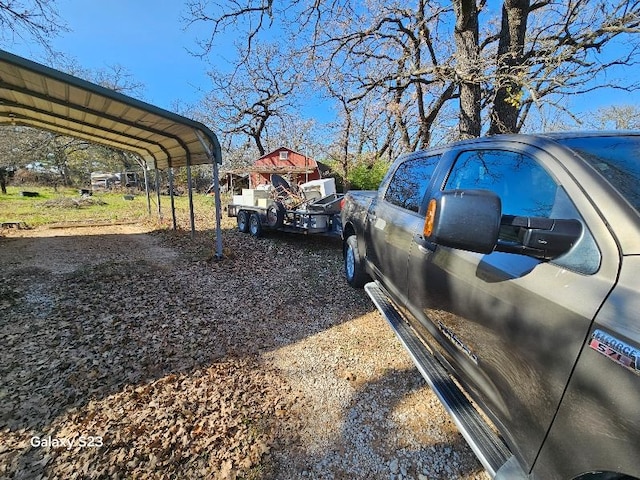 view of vehicle parking with a carport