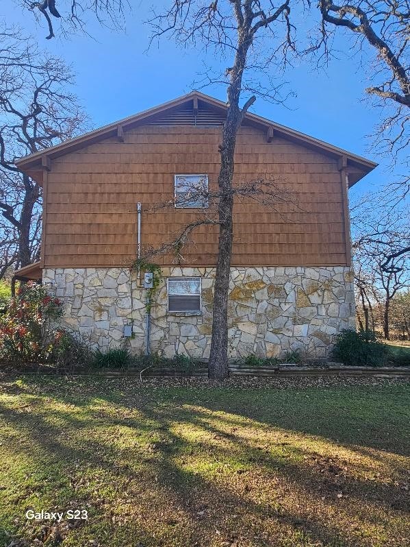 view of side of home featuring a yard