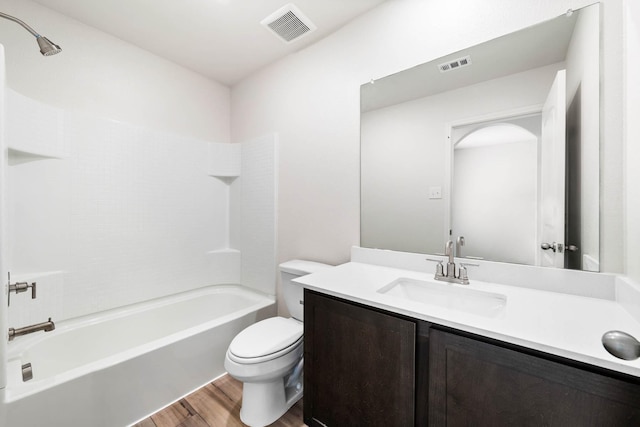 full bathroom featuring hardwood / wood-style flooring, vanity, shower / bathtub combination, and toilet