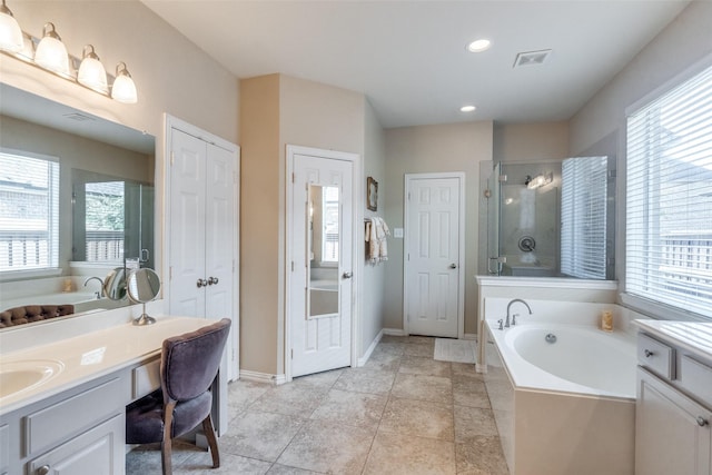 bathroom featuring vanity, separate shower and tub, a healthy amount of sunlight, and tile patterned floors