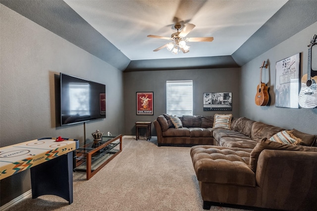 living room with lofted ceiling, ceiling fan, and carpet