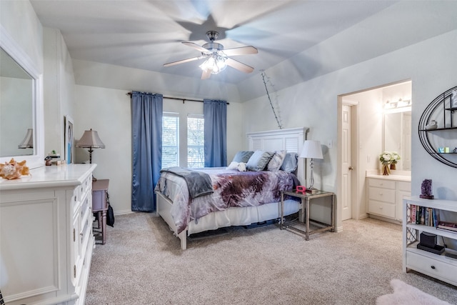 bedroom with light carpet, ensuite bath, lofted ceiling, and ceiling fan