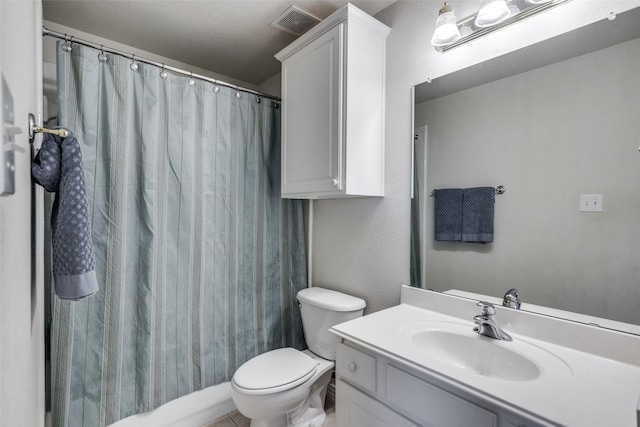 bathroom with vanity, a shower with shower curtain, and toilet