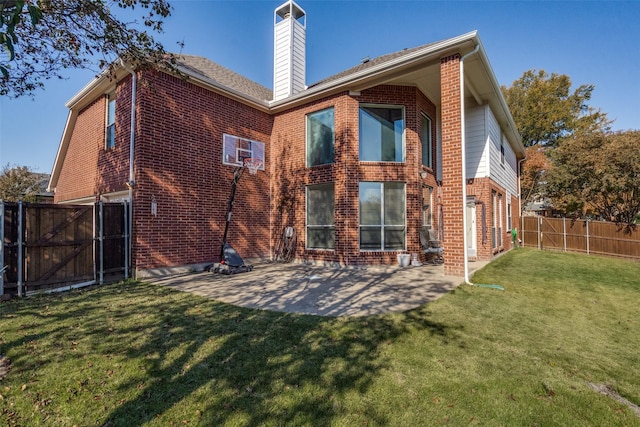 back of house featuring a yard and a patio area