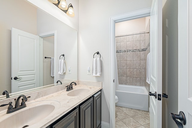 full bathroom with tiled shower / bath, tile patterned floors, toilet, and vanity