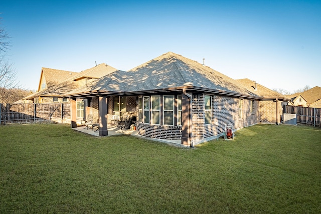 back of property featuring a patio area and a lawn