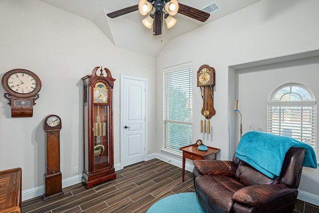 living area with lofted ceiling, a wealth of natural light, and ceiling fan