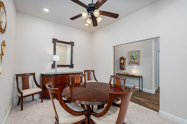 dining room with ceiling fan and dark hardwood / wood-style floors