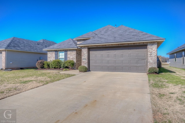 single story home with a garage and a front lawn