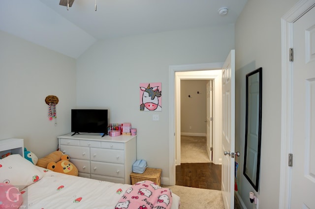 bedroom featuring lofted ceiling and dark colored carpet