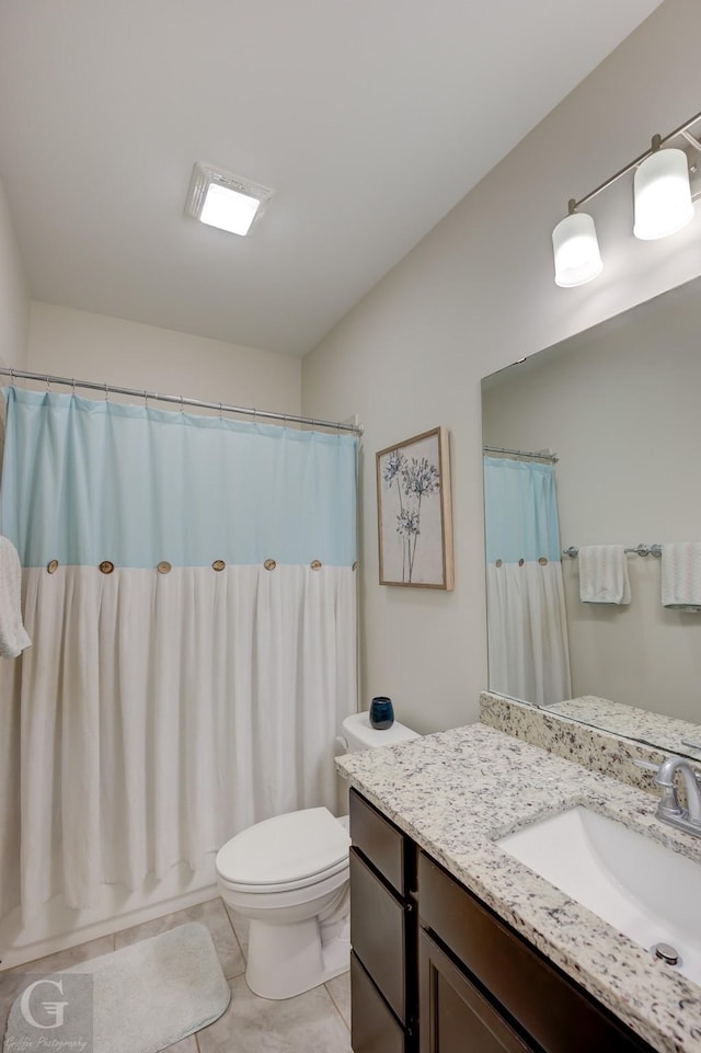 full bathroom with shower / bath combination with curtain, vanity, tile patterned floors, and toilet