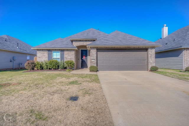 view of front of property featuring a garage and a front yard