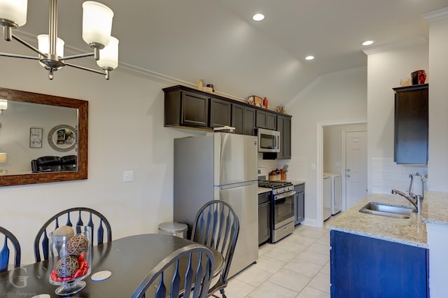 kitchen featuring sink, stainless steel appliances, tasteful backsplash, ornamental molding, and separate washer and dryer