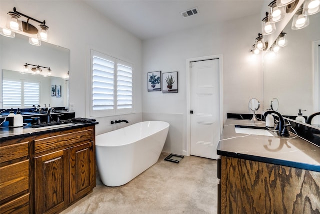 bathroom featuring a tub to relax in, plenty of natural light, and vanity