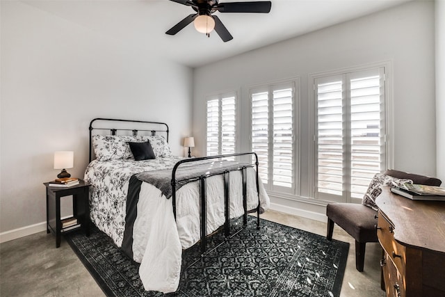 bedroom featuring ceiling fan and multiple windows