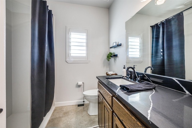 bathroom with vanity, toilet, and walk in shower