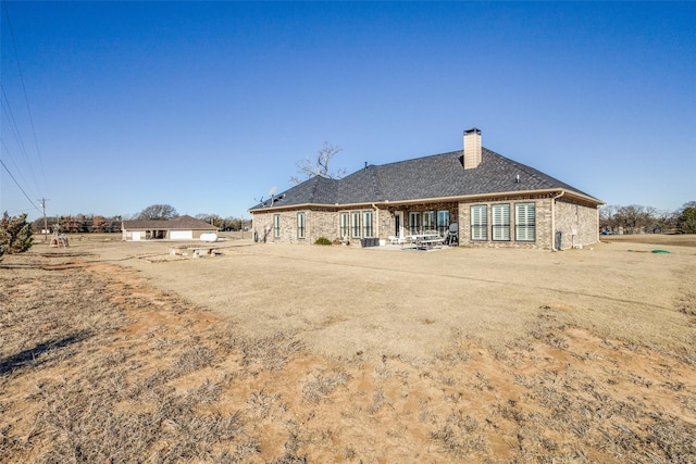 back of property featuring central AC and a patio