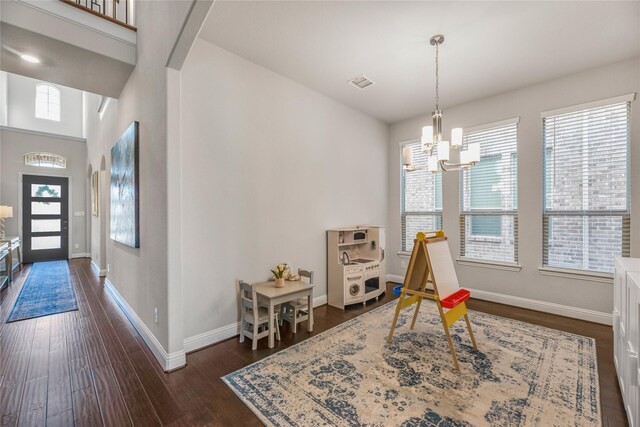 rec room featuring dark hardwood / wood-style floors and a chandelier