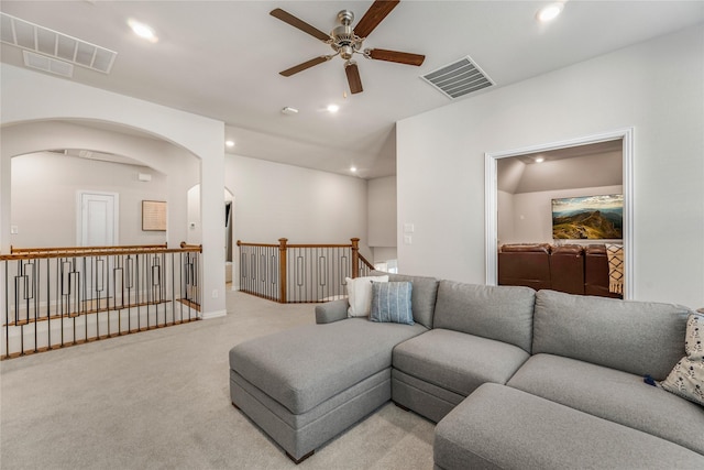 living room featuring light carpet and ceiling fan