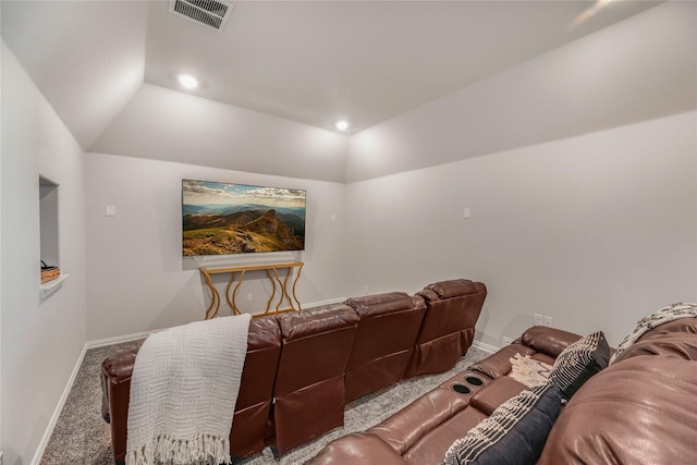 carpeted home theater room with vaulted ceiling