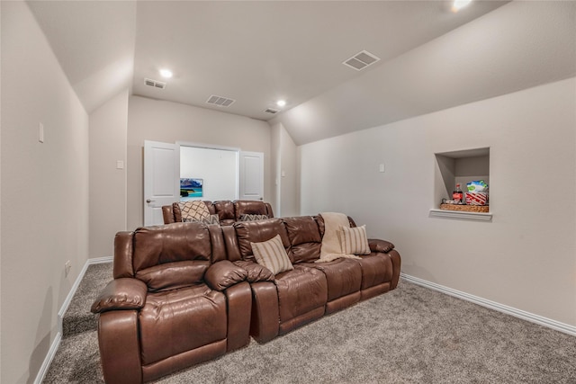 carpeted home theater room with lofted ceiling