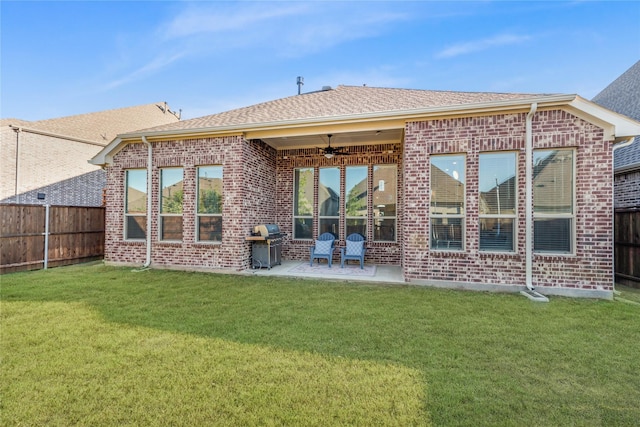 back of house with a lawn, a patio, and ceiling fan