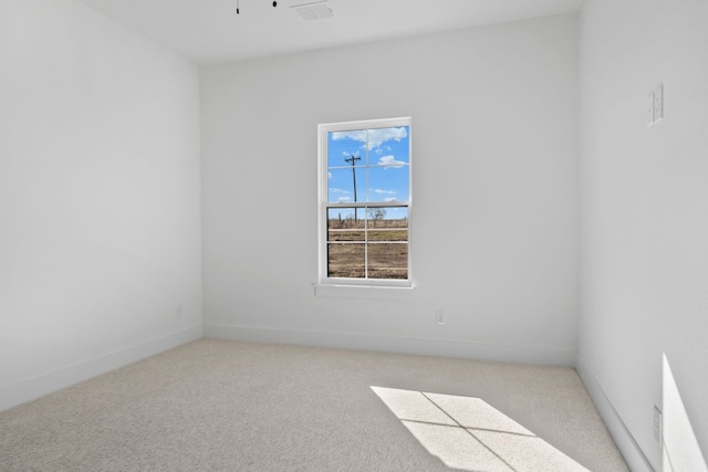 empty room featuring light colored carpet and ceiling fan