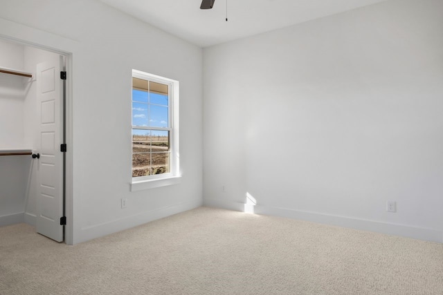 unfurnished room featuring light colored carpet and ceiling fan